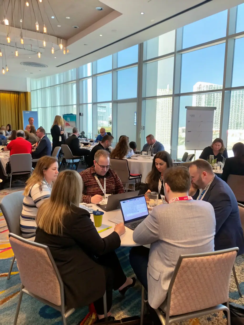 A photo of a workshop session in progress, with participants actively engaged in a hands-on activity related to digital marketing strategies at a Clearfactor conference in Birmingham.